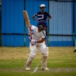 A young cricketer prepares to bat during a match in Gahunje, India.